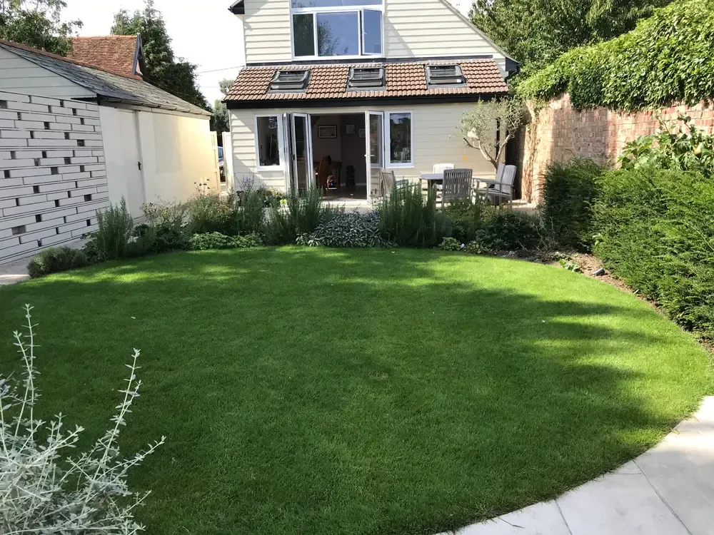 Planting softening porcelain terraces and linking to orchard views in Colchester garden