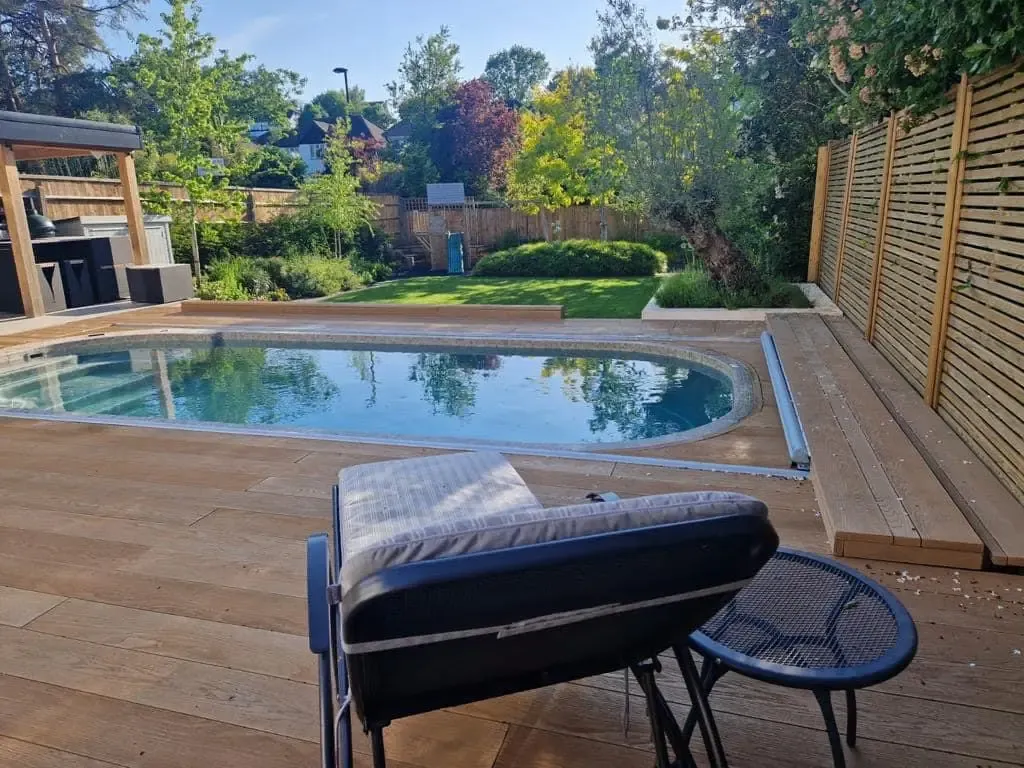 Lawn, feature olive tree and children's play area with rubber bark