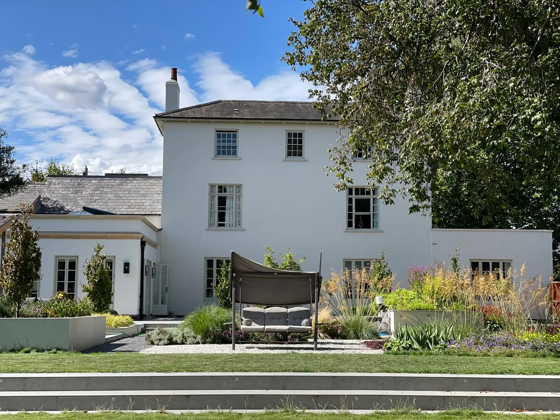 Large family garden design in Sawbridgeworth, Essex with porcelain steps and lawn